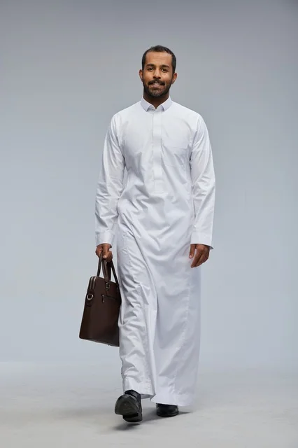 Saudi Businessman Walking with Briefcase in Thobe