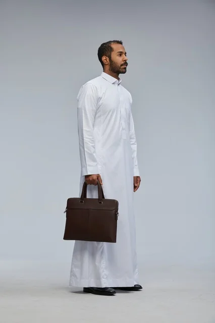 Saudi Businessman in Thobe Holding Briefcase in Studio