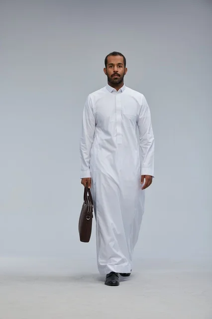 Saudi businessman holding a work bag in traditional attire