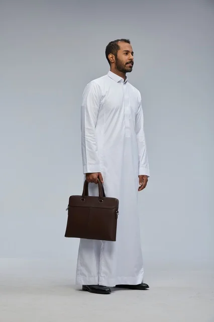 Saudi Businessman in White Thobe Holding Briefcase