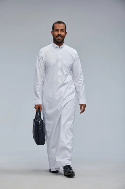 Saudi Businessman in Traditional Thobe Carrying Briefcase