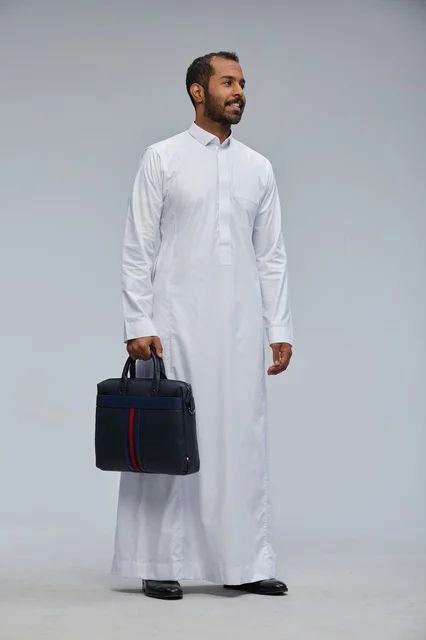 Saudi businessman holding a work bag in traditional attire