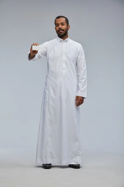 Saudi Man in Traditional Thobe Holding Blank Card