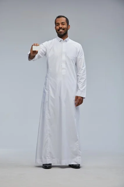 Smiling Saudi Man Holding Blank Card in Studio Thobe