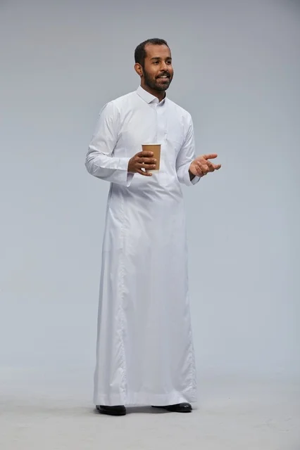 Smiling Saudi Man in Thobe Holding Coffee Cup