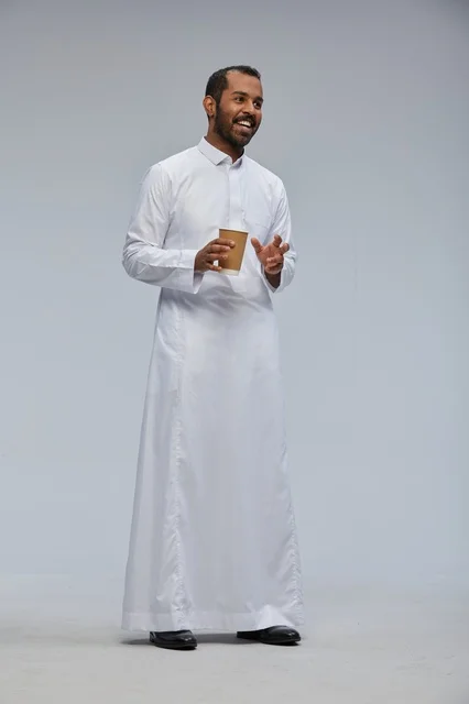 Smiling Saudi Man in Thobe Holding Coffee Cup Studio