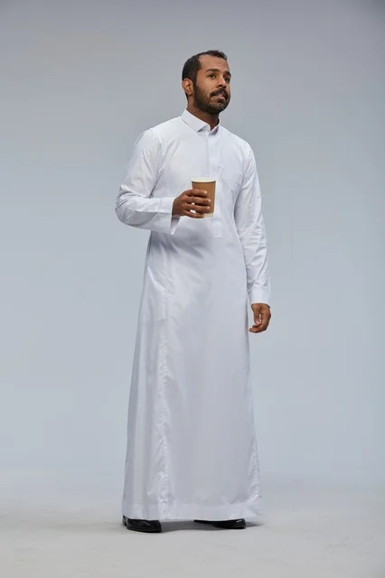 Smiling Saudi Man with Coffee Cup in White Thobe