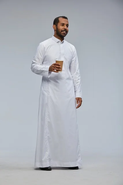 Smiling Saudi Man in Thobe Holding Coffee Cup