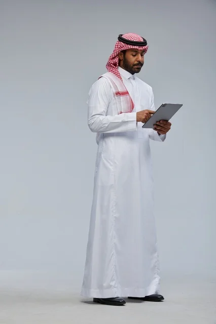 Saudi Man in Traditional Dress Using a Tablet Studio