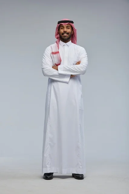 Smiling Saudi Man in Traditional Dress with Crossed Arms
