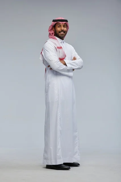 Smiling Saudi Man in Traditional Dress with Arms Crossed