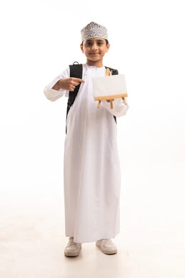 Omani Schoolboy in Traditional Dress Holding Blank Canvas