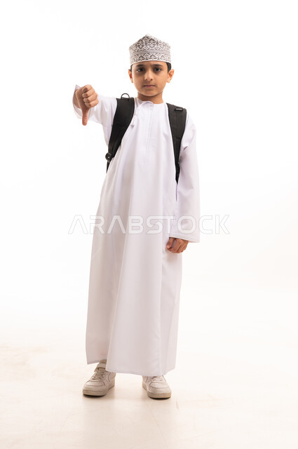 Omani Schoolboy with Backpack Giving Thumbs Down Gesture