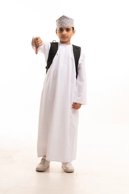 Omani Schoolboy with Backpack Giving Thumbs Down Gesture