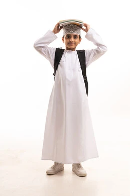 Omani Schoolboy with Backpack and Books on Head