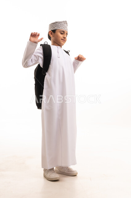 Omani Schoolboy in Traditional Dress with Backpack