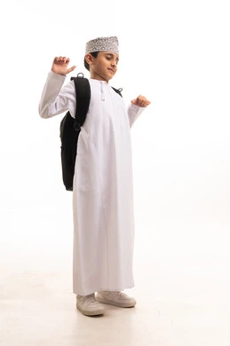 Omani Schoolboy in Traditional Dress with Backpack