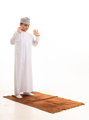 Omani Boy Praying in Traditional Dress on White Background