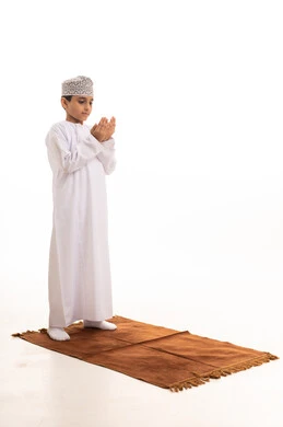 Omani Boy Praying in Traditional Dress on White Background