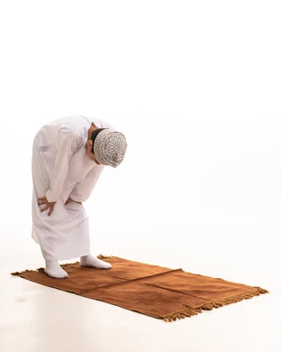 Omani Boy Bowing During Prayer on White Background