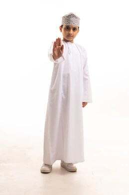Omani Boy in Traditional Dress Making Stop Gesture