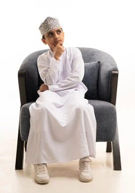 Omani Boy in Traditional Dishdasha Thinking in Studio