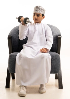 Omani Boy Exercising with Dumbbell in Traditional Dress