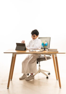 Saudi Boy Using Tablet for Distance Learning