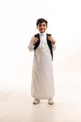 Saudi Schoolboy in White Thobe with Backpack