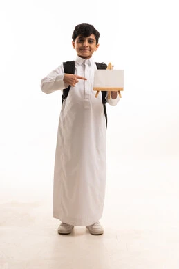 Saudi Schoolboy in White Thobe Holding Blank Board