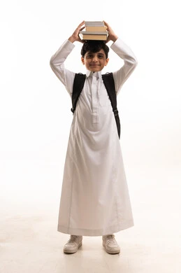 Saudi Student in White Thobe Balancing Books on Head