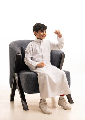 Saudi Boy in White Thobe Gesturing Success