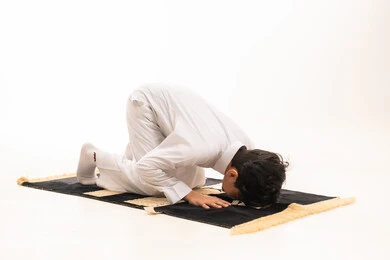 Saudi Boy Performing Sujud in White Thobe