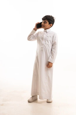 Saudi Boy in Traditional Thobe Using Smartphone Studio Shot