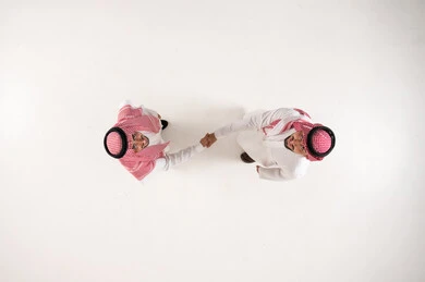 Saudi Men Handshake Overhead View on White Background
