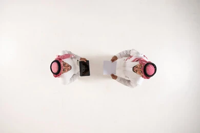 Saudi Businessmen with Tablet and Paper Top View