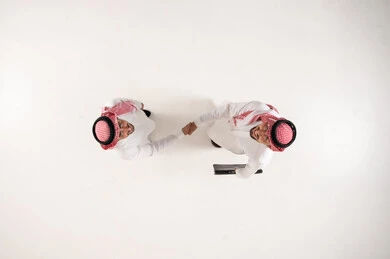 Saudi Businessmen Handshake Top View on White Background