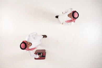 Two Saudi Men with Suitcase Top Down View on White