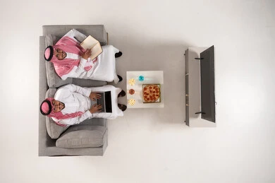 Saudi Men with Laptop and Book Overhead View