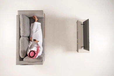 Saudi Man Using Smartphone on Sofa Top View