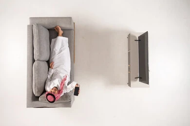 Saudi Man on Sofa with Smartphone Top View