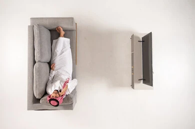Saudi Man in Traditional Dress Lying on Sofa