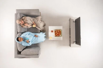 Saudi Women in Abayas Watching TV From Above