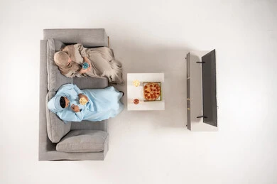 Saudi Women in Abayas Watching TV Top View