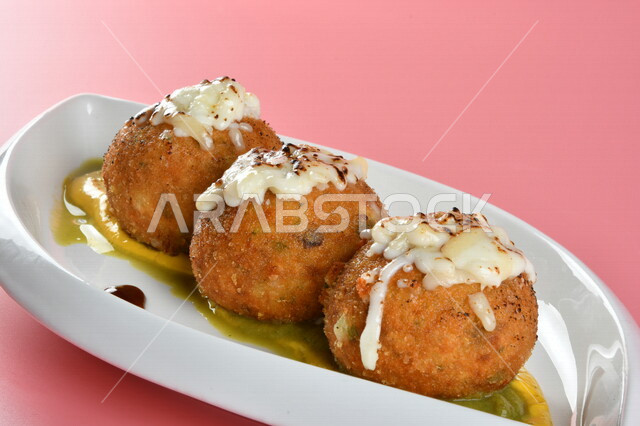 A plate of stuffed potato balls decorated with cheese, delicious meals, Arab restaurants, oriental Arab food, Ramadan food, Ramadan breakfast, delicious Arab food, recipes and food dishes