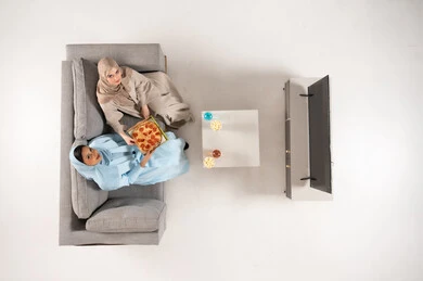 Saudi Women in Abayas Eating Pizza in Living Room