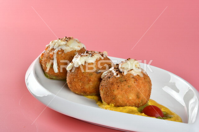 A plate of stuffed potato balls decorated with cheese, delicious meals, Arab restaurants, oriental Arab food, Ramadan food, Ramadan breakfast, delicious Arab food, recipes and food dishes