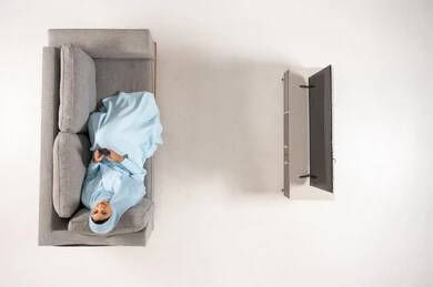 Arab Woman in Hijab Using Phone on Sofa Top View