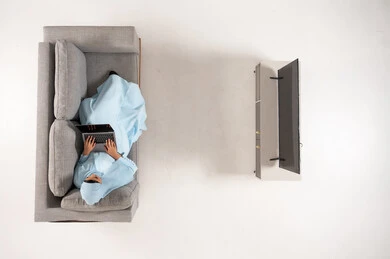 Arab Woman in Abaya Using Laptop on Sofa Overhead View