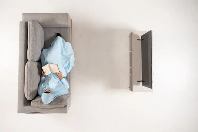 Arab Woman Reading Book on Sofa Top View